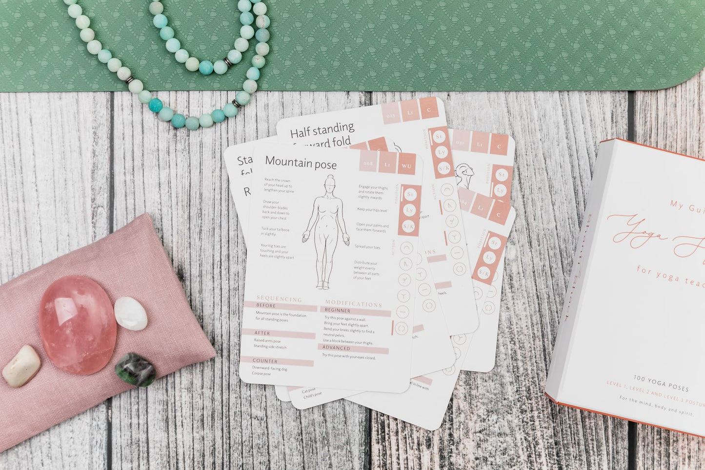 Yoga cards stacked in a pile to reveal a card with mountain pose and instructions on that pose