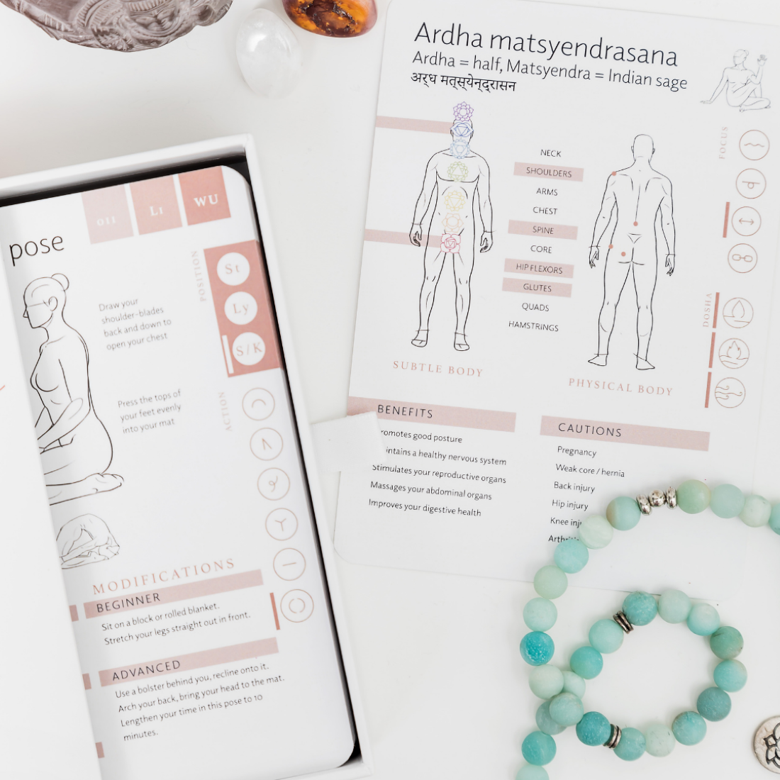 Yoga sequencing cards in a box showing illustrates yoga poses and alignment cues